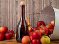 Apple cider vinegar in a bottle with apples on a wooden background. Royalty Free Stock Photo