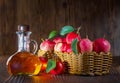 Apple cider vinegar in a glass bottle. Apples in a wicker basket.