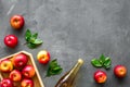 Apple cider vinegar in glass bottle and wooden tray with red apples Royalty Free Stock Photo