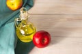 Apple cider vinegar in a glass decanter on a light wooden table. Apples nearby. Free space Royalty Free Stock Photo