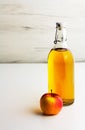 Apple cider, vinegar, juice in a glass bottle on a light background Royalty Free Stock Photo