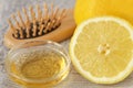 Apple cider vinegar and lemon with hair brush on grey towel - Homemade hair mask ingredients