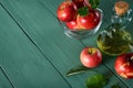 Apple cider vinegar and ripe red apples on background of green w
