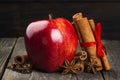 Apple, cinnamon, anisetree on a dark wooden background. Toning Royalty Free Stock Photo