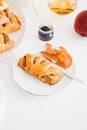 Apple cinnamon pastry rolls on white wooden table Royalty Free Stock Photo
