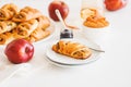 Apple cinnamon pastry rolls on white wooden table Royalty Free Stock Photo