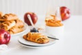Apple cinnamon pastry rolls on white wooden table Royalty Free Stock Photo