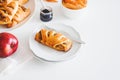 Apple cinnamon pastry rolls on white wooden table Royalty Free Stock Photo