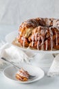 Apple cinnamon pull apart cake with a piece on a plate in front.