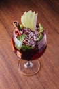 Apple cocktail with cinnamon and sliced fresh apple in wine glass on wooden table Royalty Free Stock Photo