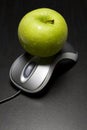 Apple on a computer mouse Royalty Free Stock Photo