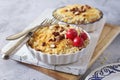 Apple crumble with almonds, two portions, red paradise apples dressing Royalty Free Stock Photo