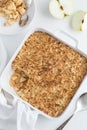 Apple crumble pie in white baking dish