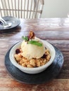 Apple crumble topped with ice-cream Royalty Free Stock Photo