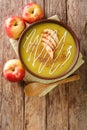Apple curry soup puree with cinnamon close-up in a plate. vertical top view Royalty Free Stock Photo