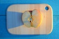 Apple cuted in half on a wooden board on turquoise table with a long blue shadow Royalty Free Stock Photo