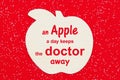 An apple a day keeps the doctor away message with a wood apple Royalty Free Stock Photo