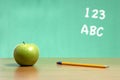 An apple on a desk in a classroom Royalty Free Stock Photo