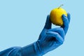 An apple in the doctor& x27;s hand. Background, selective focus. blue medical backdrop