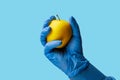 An apple in the doctor& x27;s hand. Background, selective focus. Isolated blue medical backdrop