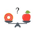 Apple and doughnut on scales. Diet concept. Healthy and unhealthy food. Weight loss, healthy lifestyle, proper nutrition