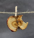 Apple dried bitten with a clothespeg
