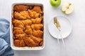 Apple dumplings baked in white dish, overhead shot