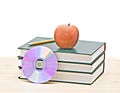 Apple, dvd, and books Royalty Free Stock Photo