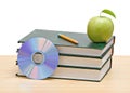 Apple, dvd, and books Royalty Free Stock Photo