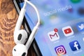 Apple Earpods and iPhone with social media apps - Facebook, YouTube, Instagram, Gmail, Twitter