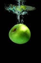 Apple falling into water Royalty Free Stock Photo