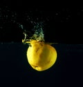 Apple falling through water Royalty Free Stock Photo
