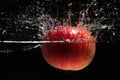 Apple falling in water Royalty Free Stock Photo