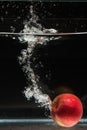 Apple falling in water Royalty Free Stock Photo