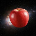 An apple floating in space in front of the galaxy. Royalty Free Stock Photo