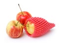Apple in a foam mesh sleeve on white Royalty Free Stock Photo