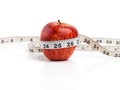 Apple, food and tape measure with red fruit in studio isolated on white background for diet, health or nutrition. Size Royalty Free Stock Photo