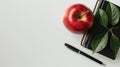 Apple and four books and a pen on a white background with a place for text Royalty Free Stock Photo