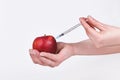 Apple fruit being injected with syringe