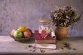 apple fruit and old book with seashell decoration Royalty Free Stock Photo