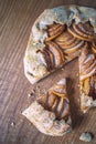 Apple galette - pie on white baking parchment. Copy space, flat lay Royalty Free Stock Photo