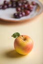 Apple with grapes in background