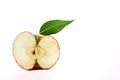Apple with green leaf, cut in half on white Royalty Free Stock Photo