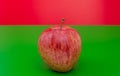 Apple on green and red background