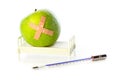 Apple in hospital bed, thermometer in front Royalty Free Stock Photo