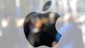 Apple Inc. logo on a glass against blurred crowd on the steet. Editorial 3D rendering