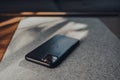 Apple iPhone 11 Pro Max in leather case on a table, selective focus