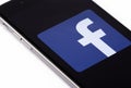 Apple iPhone 6s and logo of Facebook on the screen. Facebook is Royalty Free Stock Photo