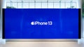 Apple iPhone 13 smartphone new release logo advertisement on ads display screen in shopping mall