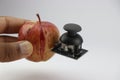 Apple with joystick module attached showing the concept of integrating technology with organic world